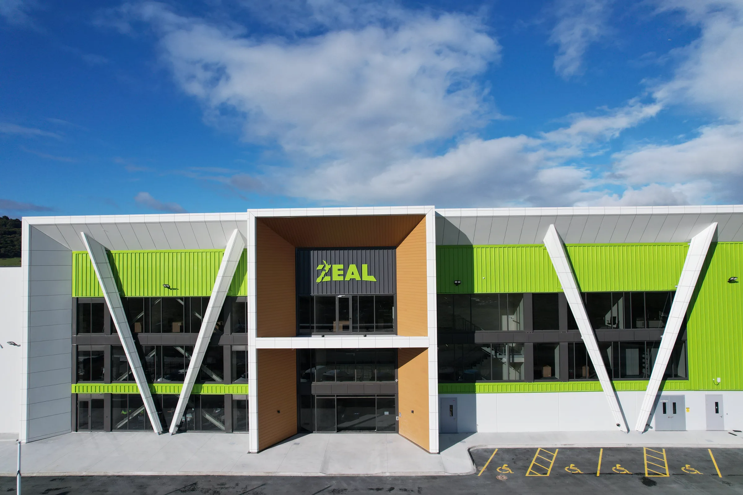 Main entrance and glazed facade of the completed factory