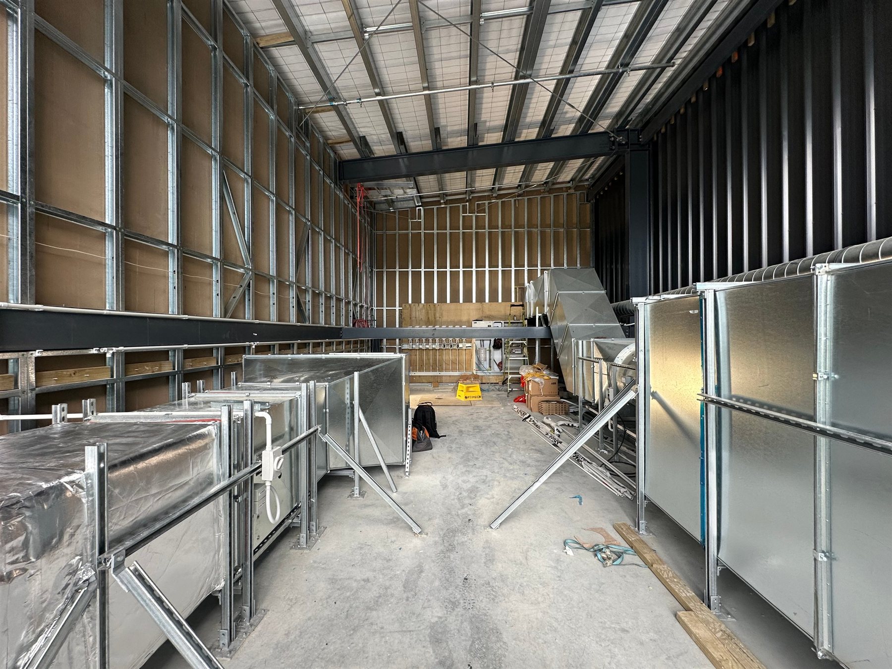 Ventilation ductwork being installed inside a factory