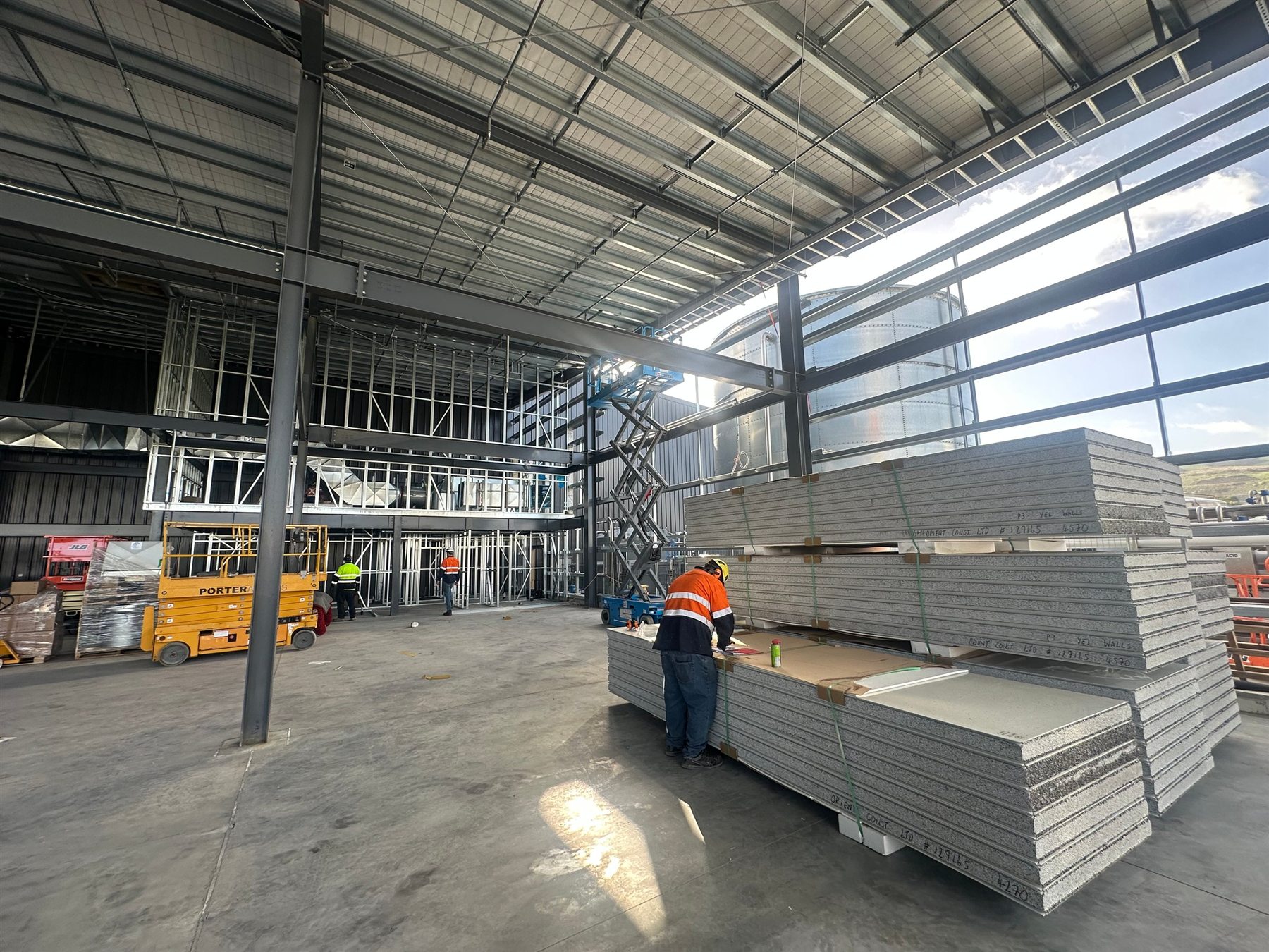 Interior factory fit-out with workers and wall panels